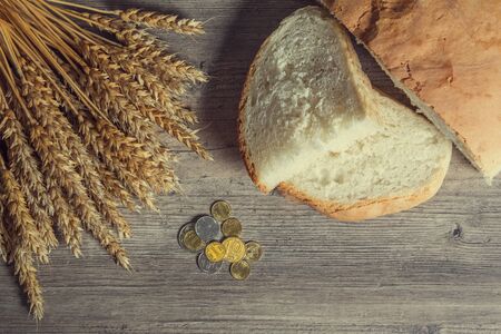 Kazakhstan tenge on the table with wheat ears and bread. Bread in Kazakhstan and Kazakhstan wheat. Grain harvestの写真素材