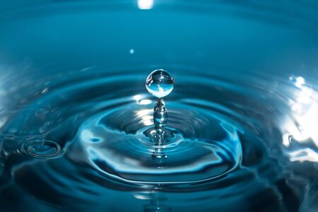 Splash of water close-up. Water drop. A blue drop of water. Falling water. The rain closeup.