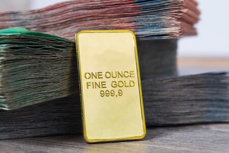 Paper banknotes tenge KZT with gold ingot. Tenge is the national currency of Kazakhstan. bank of Kazakhstanの写真素材