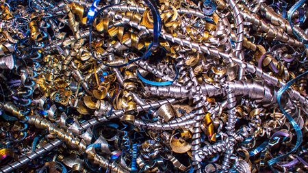 Abstract color background of metal shavings. Processing of ferrous and non-ferrous metals in a...