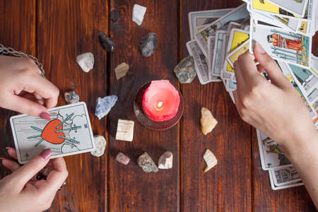 Bangkok,Thailand,March.15.20.The Gypsy lays out Tarot cards and guesses for the future. Christmas fortune telling and fortune telling. Magical sessions with the cards. Women's hands and Tarot cardsのeditorial素材