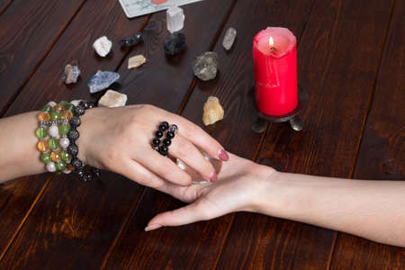 Bangkok,Thailand,March.15.20.Fortune teller predicts fate using a magic ball,stones and a lit candle.A Gypsy telling fortunes by the hand.Christmas fortune telling and fortune telling.Psychic at workのeditorial素材
