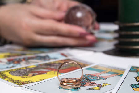 Bangkok, Thailand, March.15.20.Wedding rings are on Tarot cards. The Gypsy lays out Tarot cards and guesses for the future. Magic sessions with talking Tarot cards with heart and wedding ringsのeditorial素材
