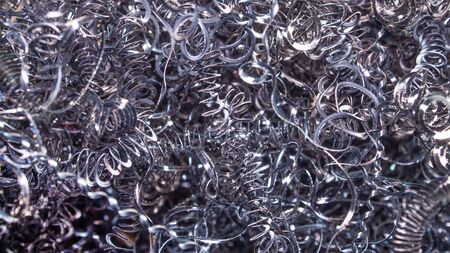 Abstract color background of metal shavings. Processing of ferrous and non-ferrous metals in a...
