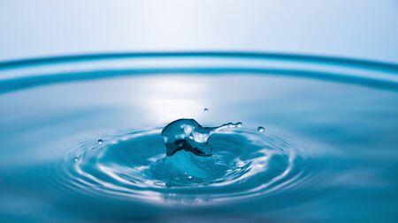Water splash close-up. Crown of blue water. Water drop. Frozen splashes.
