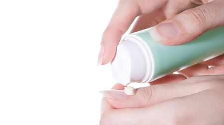 Apply a restorative cream or lotion to the cuticle or skin of the handsの写真素材