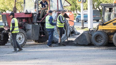 Moscow, Russia-07.05.2020: Road works. Workers repair the road surface and asphalt the street....