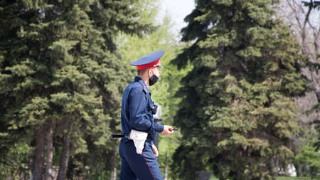 Petropavlovsk, Kazakhstan - 29.04.2020: Kazakh police officer in a protective face mask during the...