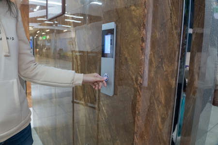 The girl calls the Elevator, ride the Elevator in the office, shopping center or business center to...