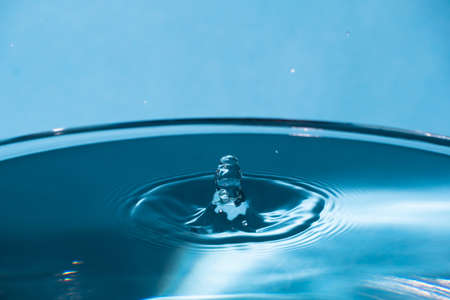 Abstract an outbreak of water. Splash of water close-up. Frozen water drop photographed at high speed. Slow dripping of liquid with air bubbles. Nature backgrounds or Wallpaper.Frozen liquid splashesの写真素材
