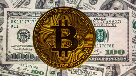 Background with money in American hundred-dollar bills and bitcoin.The monetary background.A screen...