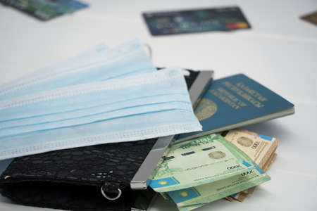 Quarantine and border closure in Kazakhstan for coronavirus. On the table are money in tenge with...