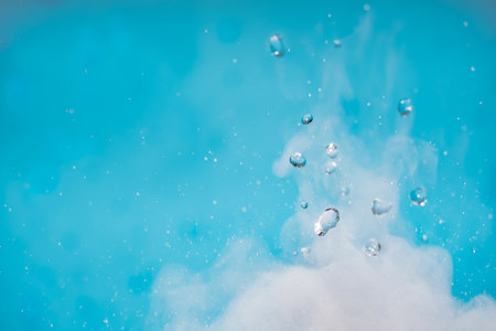 Water drop. Chemical reaction with boiling swirling water splashes, jumping drops with a large release of heat and gas vapor. Water splashing is a physical phenomenonの写真素材