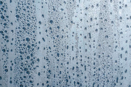Raindrops on the glass in rainy weather.の写真素材