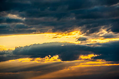 The heavenly light of the sun.Dramatic evening sky with clouds and rays of the sun. Sunlight at...
