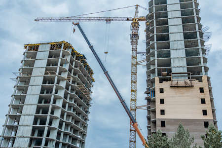 Construction site with a crane.Long-term construction.A new building under construction,bottom-up...