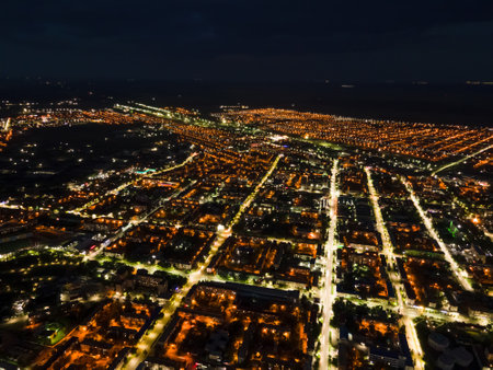 The nightlife of the city,the light of the night city from a height.Busy car traffic on city streets at night.Urban areas and the intersection of streets in the dark illuminated by lights and lanternsの写真素材