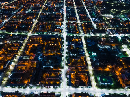 The nightlife of the city,the light of the night city from a height.Busy car traffic on city streets at night.Urban areas and the intersection of streets in the dark illuminated by lights and lanternsの写真素材