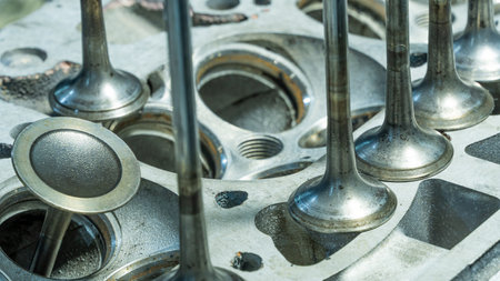 Car engine valves close up.Part of car's motor.Machinery detail of modern gasoline engine repair of cylinder head.Installing the valve of an overhauled engine.Mechanism automobile.Workshop motor carの写真素材
