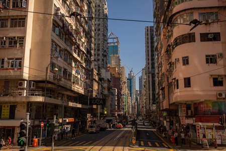 Hong Kong, China - November 25, 2019: Central streets of Hong Kong. Taxis, buses, and trams go down...