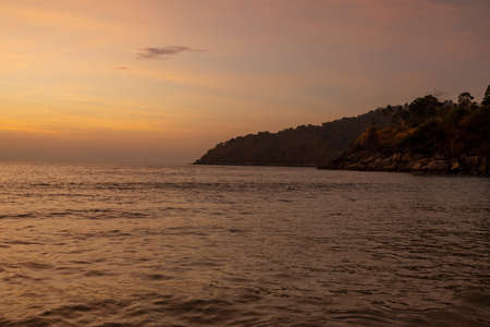 Landscape of sunset tropical beach with hills in the background in Phuket, Thailand