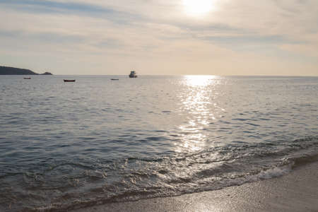 Beach in Thailand with boats and hills in the background. Phuketの写真素材
