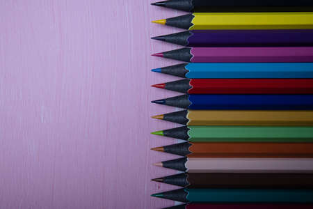 Row of color blackwood pencils at the right of the image on pink background with copy space. Education conceptの写真素材