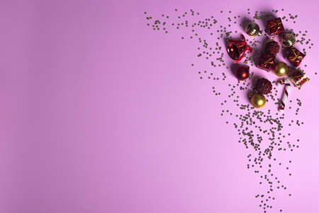 Christmas and New Year minimalism composition. Red and gold decorations on pink backgroundの写真素材