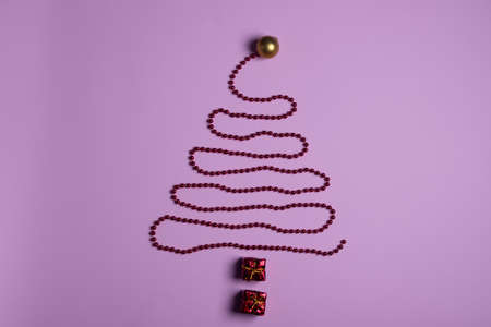 Christmas and New Year minimalism composition. Christmas tree made of pink decoration on pink backgroundの写真素材