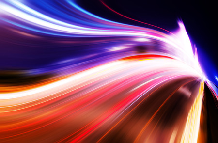 Moving cars with fast blurred trail of headlights