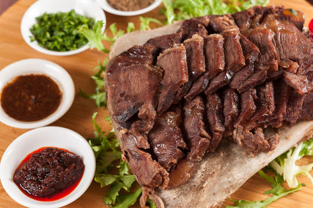 Roast Beef in a bone with sauceの写真素材
