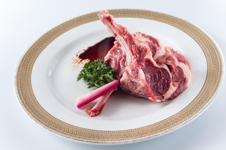 raw fresh lamb chop on white backgroundの写真素材