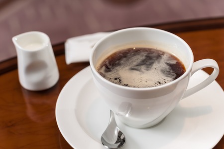 A cup of coffee on the tableの写真素材