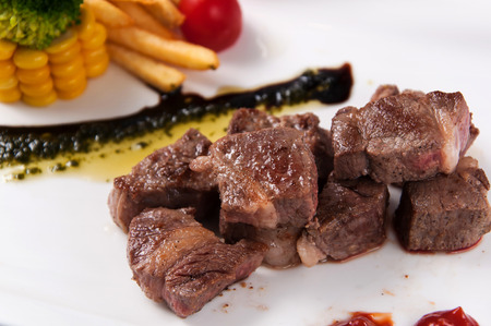 Fried beef with French fries and cornの写真素材