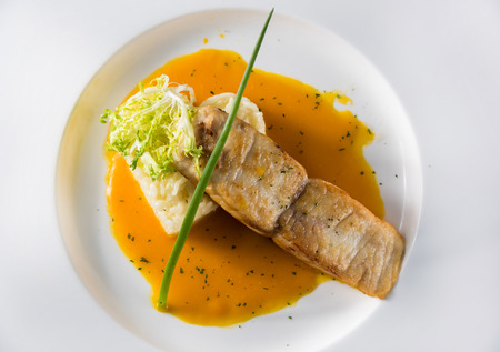 Grilled cod with green asparagus, green salad, lemon Pumpkin Cream Sauceの写真素材