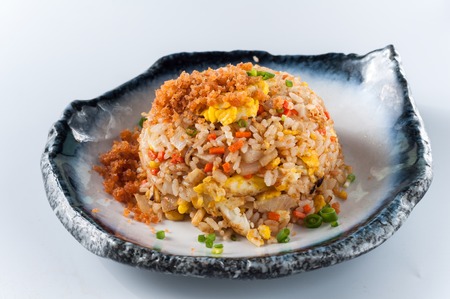 Chinese cuisine - salmon fish and egg fried rice on white backgroundの写真素材