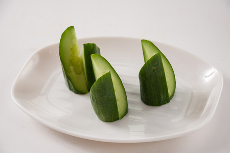 cucumber slice on white plateの写真素材