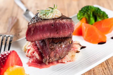 medium roast rib-eye steak on white plateの写真素材
