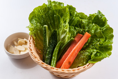 lettuce, carrot, cucumber, green pepper in the basketの写真素材