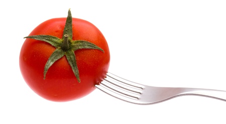 Red tomato on a plug isolated on the whiteの写真素材