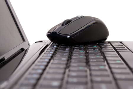 Laptop and mouse on white