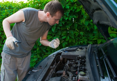 The man repairs the carの写真素材