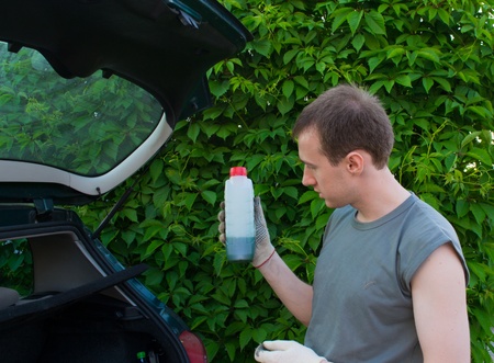 The man with a lubricating oil bottleの写真素材