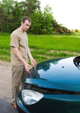 The man opens a car cowlの写真素材