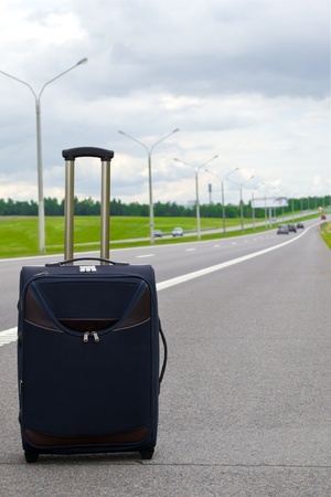 suitcase on roadの写真素材