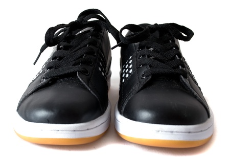 Black trainers with a yellow soleの写真素材