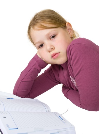 Little girl sleeping while doing her studiesの写真素材