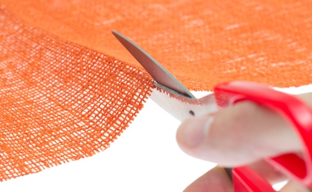 hand with the scissors cut the clothの写真素材