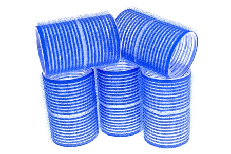 a few blue hair curlers on a white backgroundの写真素材