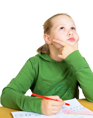 little girl dreaming at the table on whiteの写真素材